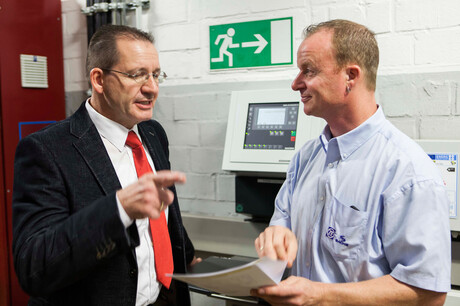 Kaeser Kompressoren engineer Hages and ZF Friedrichshafen employee Baumgarten discussing the compressed air station plans