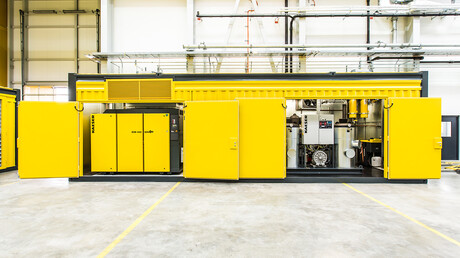 Open compressed air container showing rotary screw compressors from Kaeser Kompressoren.